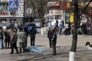 Investigators inspect the body of a victim killed by a gunman in Belgorod