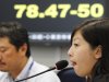 A Tokyo money brokerage employees sit in front of an electronic update board, flashing the current Japanese yen rate against a U.S. dollar in Tokyo, Friday, June 1 2012. The dollar fell to 78.33 Japanese yen from 79.07 yen in New York Thursday, May 31, 2012.  (AP Photo/Koji Sasahara)