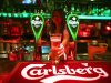 A bartender serves a glass of Carlsberg beer at a bar in Kuala Lumpur