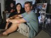 Michelle Trenum, left, and her husband Gil Trenum, pose next to photos of their son, Austin Trenum, at their Nokesville, Va., home, in this photo taken Wednesday, Aug. 24, 2011. Austin Trenum's bed remains half-made, the way a typical teenager would leave it. On a nearby shelf is his scarred black helmet, the one he was wearing when he tackled the quarterback near the sidelines during Brentsville High's game against Handley some 11 months ago. Austin's mouthpiece remains tucked neatly in the face mask, ready to be taken out for the next play. (AP Photo/Luis M. Alvarez)