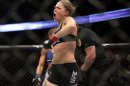 Ronda Rousey celebrates defeating Liz Carmouche after their UFC 157 women's bantamweight championship mixed martial arts match in Anaheim, Calif., Saturday, Feb. 23, 2013. Rousey won the first women's bout in UFC history, forcing Carmouche to tap out in the first round. (AP Photo/Jae C. Hong)
