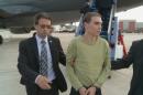 This photograph, courtesy of the Service de Police de la Ville de Montreal (SPVM) shows Luka Rocco Magnotta (C) escorted by police upon arrival from Germany on June 18, 2012 in Mirabel, Quebec