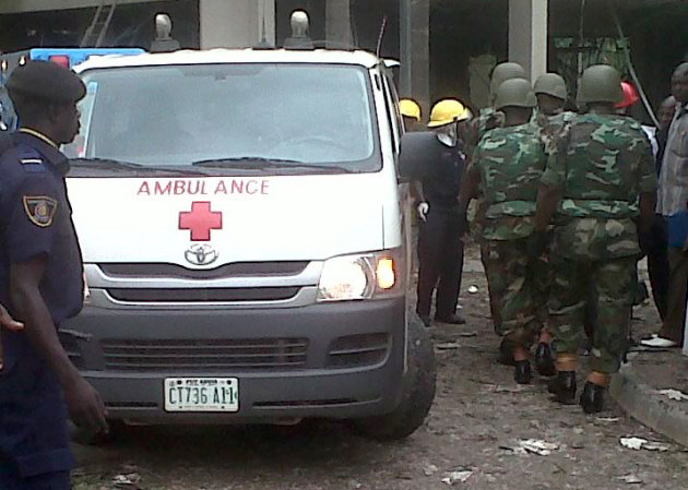 This image released by Saharareporters shows an ambulance, firefighters and rescue workers after a large explosion struck the United Nations' main office in Nigeria's capital Abuja Friday Aug. 26, 201