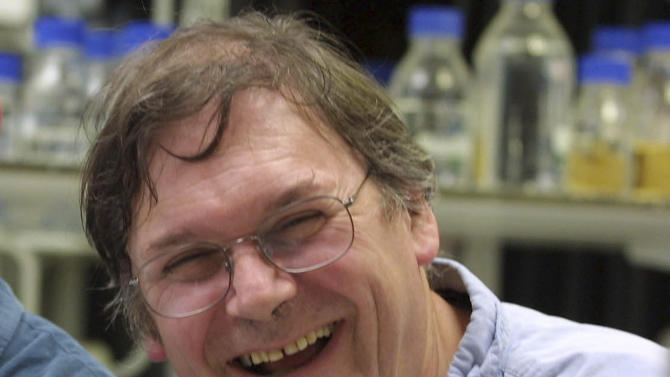 FILE - A Monday Oct. 8, 2001 photo from files of Dr. Tim Hunt, winner of the Nobel Prize for Medicine, in a laboratory in London. The Nobel Prize-winning British scientist has apologized Wednesday, June 10, 2015, for saying the "trouble with girls" working in science labs is that it leads to romantic entanglements and harms science. Tim Hunt made the comments at the World Conference of Science Journalists in South Korea, according to audience members. (AP Photo/Alastair Grant, File)