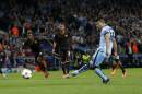 Manchester City's Sergio Aguero scores a penalty during a Champions League group E soccer match between Manchester City and Roma at the Etihad Stadium, Manchester, England, Tuesday, Sept. 30, 2014. (AP Photo/Jon Super)