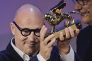 Director Gianfranco Rosi celebrates his Golden Lion for the movie 'Sacro GRA' during the awards ceremony of the 70th edition of the Venice Film Festival in Venice, Italy, Saturday, Sept. 7, 2013. (AP Photo/Domenico Stinellis)