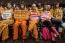 Activists from the antiwar group CodePink, including co-founder Medea Benjamin, second from right, hold silent protest at the Senate Armed Services Committee during a hearing on the detention center in Guantanamo, Cuba, Thursday, Feb. 5, 2015, on Capitol Hill in Washington. A week ago, the same group drew the ire of Armed Services Chairman Sen. John McCain, R-Ariz., when they interrupted a hearing with former Secretary of State Henry Kissinger and charged the witness table. (AP Photo/J. Scott Applewhite)