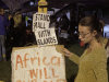 Protesters hold a night vigil as talks at the climate change summit stall in Durban, South Africa, Friday, Dec 9, 2011. Negotiators from Europe, small islands threatened by rising oceans and the world's poorest countries sought to keep alive the only treaty governing global warming and to move on to the next stage, struggling against an unlikely alliance of the United States, China and India. Poster reads: Africa will burn.  (AP Photo/Schalk van Zuydam)