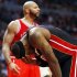 Miami Heat's James holds his face after a play as Chicago Bulls' Boozer looks on, during their NBA basketball game in Chicago