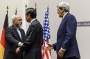 (L to R) Iranian Foreign Minister Mohammad Javad Zarif, Chinese Foreign Minister Wang Yi and US Secretary of State John Kerry shakes hands after a statement early on November 24, 2013 in Geneva