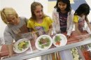 Students at Rose Hill Elementary School (L-R) Destiny Huges, Alexis Reubenstein and Sami Escadjeda choose the salad bar for lunch in Commerce City