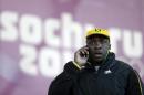 Winston Watts, the driver for JAM-1 of Jamaica, speaks on the phone after arriving at the sliding center during a training session for the men's two-man bobsled at the 2014 Winter Olympics, Wednesday, Feb. 5, 2014, in Krasnaya Polyana, Russia. Watts and his team were unable to practice because the Jamaican team equipment and luggage did not arrive in Sochi. (AP Photo/Natacha Pisarenko)