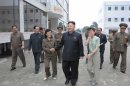 Women greet North Korean leader Kim Jong-Un as he goes around to provide field guidance to Changjon Primary School