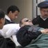 Former Egyptian president Hosni Mubarak lies on a gurney bed while leaving the courtroom at the police academy in Cairo