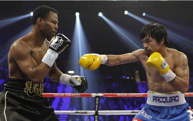 Shane Mosley, left, and Manny Pacquiao exchange punches in the second round during a WBO welterweight title bout, Saturday, May 7, 2011, in Las Vegas.  (AP Photo/Isaac Brekken)