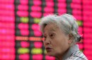 An investor reacts as she looks at the stock price monitor at a private securities company Wednesday, June 27, 2012, in Shanghai, China. Asian stock markets edged up Wednesday as rising home prices in the U.S. eased jitters over the robustness of the world's No. 1 economy. (AP Photo)