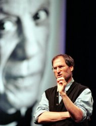 FILE - In this Oct. 2, 1997, file photo, Steve Jobs of Apple Computer, speaks during the Seybold publishing conference in San Francisco, in front of a poster of artist Pablo Picasso from Apple's latest advertising campaign. Apple on Wednesday, Oct. 5, 2011 said Jobs has died. He was 56. (AP Photo/Thor Swift, File)