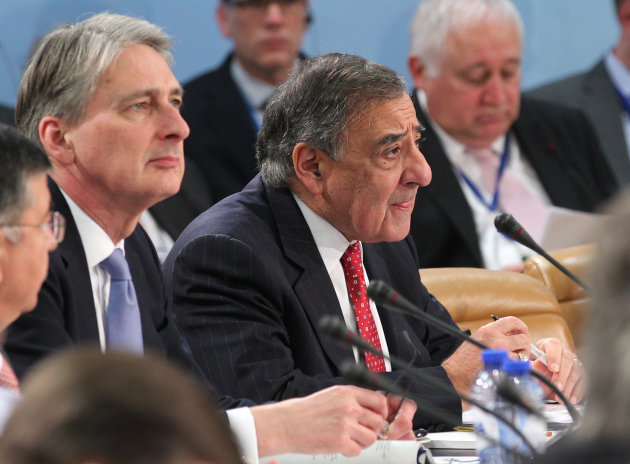U.S. Secretary of Defense Leon Panetta, right, and Britain's Secretary of State for Defense Philip Hammond attend the two-day NATO defense ministers meeting to discuss Syria and Afghanistan, at NATO headquarters in Brussels, Thursday, Feb. 21, 2013. The head of NATO urged member countries Thursday to stop cutting their defense budgets in response to tough economic times, saying continued reductions will compromise the safety of all of the military alliance’s 28 members. (AP Photo/Yves Logghe)