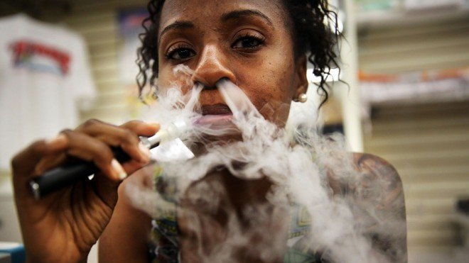A customer smokes an electronic cigarette at Vape New York, a dedicated vaporized nicotine retailer in New York City. 