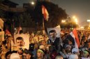 Supporters of deposed Egyptian president Mursi hold up Egyptian national flags and posters of Mursi, as they chant slogans during a rally in Cairo