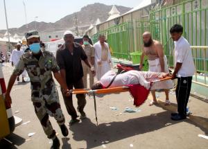 Hajj pilgrims and Saudi emergency personnel carry a&nbsp;&hellip;
