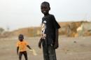 Children of South Sudanese stand at Mandela IDP camp on the outskirts of Khartoum
