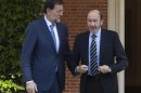 Spain's PM Rajoy talks with opposition leader Perez Rubalcaba before their meeting in Madrid