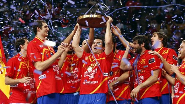 Spanish players celebrate with the trophy as they won the gold medal during the Men's Handball World Championship at the Palau Sant Jordi arena in Barcelona