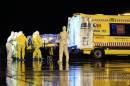 A Spanish Defense Ministry photo shows aid workers and doctors transferring Catholic missionary Manuel Garcia Viejo, who contracted the deadly Ebola virus, upon his arrival in Spain on September 22, 2014