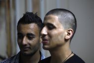 Ayman al-Sayed, 19, right, with his hair cut, stands with his friend Mohammed Hanouna, 18, left, in Gaza City, Sunday, April 7, 2013. Al-Sayed used to have shoulder-length hair but says he was grabbed by Hamas police in a sweep along with other young men with long or gel-styled spiky hair last week, and that police shaved everyone's head. Hanouna still wears the hair-style that can now get young men in trouble in Gaza, during the Islamic militants latest attempt to impose their hardline version of Islam on Gaza. (AP Photo/Adel Hana)