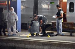 Police work on a platform next to a Thalys …