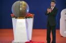Chinese President Xi Jinping applauds after unveiling a sculpture during the opening ceremony of the Asian Infrastructure Investment Bank (AIIB) in Beijing