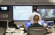 Officials at the American Red Cross in Greater New York Emergency Operations Center discuss their preparations for the landfall of Hurricane Irene in New York August 25, 2011. REUTERS/Lucas Jackson