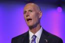 Florida Republican Gov. Rick Scott speaks at a ceremony opening new newsroom facilities for the Univision and Fusion television networks in Doral