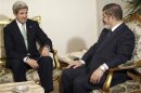 Egypt's President Mursi speaks with U.S. Secretary of State Kerry during their meeting in Cairo