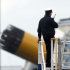 An Italian Navy officer talks on a walkie-talkie in the harbor of the Tuscan island of Giglio, Italy, where the cruise ship Costa Concordia run aground, Monday, Jan. 23, 2012. Salvage experts can begin pumping fuel from a capsized cruise ship as early as Tuesday to avert a possible environmental catastrophe and the ship is stable enough that search efforts for the missing can continue, Italian officials said. (AP Photo/Pier Paolo Cito)