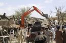 Villagers gather at the site of a car bomb attack in Urgon district eastern province of Paktika