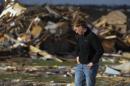 Paul Tubbs of Washington, Ill., looks over the remains of his home on Devon Lane in Washington after a tornado tore through the north part of Washington on Sunday, Nov. 17, 2013. (AP Photo/Peoria Journal Star, Ron Johnson) MANDATORY CREDIT