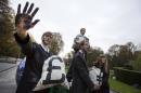 Activists dressed as corporate lobbyists hold bags of coal and put up blackened hands as they demonstrate outside an EU summit in Brussels, on Thursday, Oct. 23, 2014. Demonstrators called for EU leaders to resist pressure by the fossil fuel industry and agree an EU 2030 climate and energy package. EU leaders will gather Thursday for a two-day summit in which they will discuss energy and climate change. (AP Photo/Virginia Mayo)