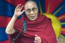 The Dalai Lama addresses an audience near the Stone Circle as he visits the Glastonbury Festival of Music and Performing Arts on Worthy Farm near the village of Pilton in Somerset, South West England on June 28, 2015
