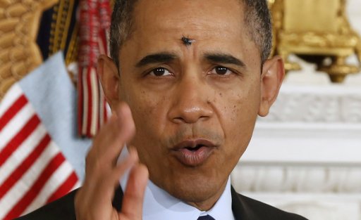 A fly lands on the head of U.S. President Barack Obama at the White House in Washington