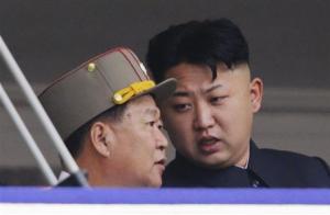North Korean leader Kim speaks to Choe, director of the General Political Bureau of the KPA, during a parade in Pyongyang