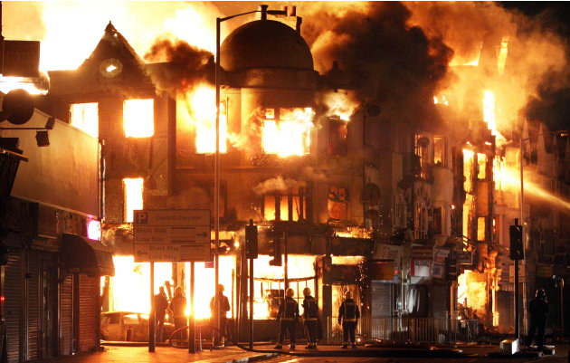 A property is on fire near Reeves Corner in Croydon, south London Tuesday, Aug. 9, 2011. A wave of violence and looting raged across London and spread to three other major British cities on Tuesday, a