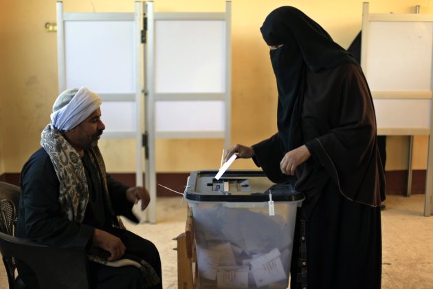 An Egyptian woman casts her vote during the second round of a referendum on a disputed constitution drafted by Islamist supporters of President Mohammed Morsi in Fayoum, about 100 kilometers (62 miles) south of Cairo, Egypt, Saturday, Dec. 22, 2012.(AP Photo/Khalil Hamra)