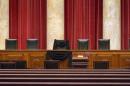 Supreme Court Justice Antonin Scalia's courtroom chair is draped in black to mark his death as part of a tradition that dates to the 19th century, Tuesday, Feb. 16, 2016, at the Supreme Court in Washington. Scalia died Saturday at age 79. He joined the court in 1986 and was its longest-serving justice. (AP Photo/J. Scott Applewhite)