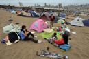 Families camp on the sand hills surrounding Iquique, 1,950 km north of Santiago on April 4, 2014 in fear their homes might collapse