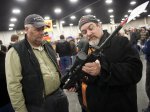 FILE - In a Saturday, Jan. 5, 2013 file photo, gun owners discuss a potential sale of an AR-15, during the 2013 Rocky Mountain Gun Show at the South Towne Expo Center in Sandy, Utah. Nearly six in 10 Americans want stricter gun laws in the aftermath of last month's deadly school shooting in Connecticut, with majorities favoring a nationwide ban on military-style, rapid-fire weapons and limits on gun violence depicted in video games and movies and on TV, according to a new Associated Press-GfK poll. A lopsided 84 percent of adults would like to see the establishment of a federal standard for background checks for people buying guns at gun shows, the poll showed. President Barack Obama was set Wednesday, Jan. 16, 2013 to unveil a wide-ranging package of steps for reducing gun violence expected to include a proposed ban on assault weapons, limits on the capacity of ammunition magazines and universal background checks for gun sales.(AP Photo/The Deseret News, Ben Brewer, File) NO SALES; MAGS OUT; SALT LAKE TRIBINE OUT;  PROVO DAILY HERALD OUT