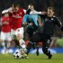 Arsenal's Podolski is challenged by Bayern Munich's Schweinsteiger during their Champions League soccer match at the Emirates Stadium in London