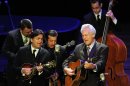 Del McCoury, playing guitar, leads his band during the funeral service for banjo great and bluegrass pioneer Earl Scruggs at the Ryman Auditorium on Sunday, April 1, 2012, in Nashville, Tenn. Scruggs died Wednesday, March 28, 2012. He was 88. (AP Photo/Joe Howell, Pool)