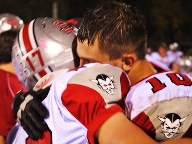 St. Clairsville players Logan Thompson and Michael Ferns embrace following Thompson's emotional touchdown — USA Today/Gannett Media